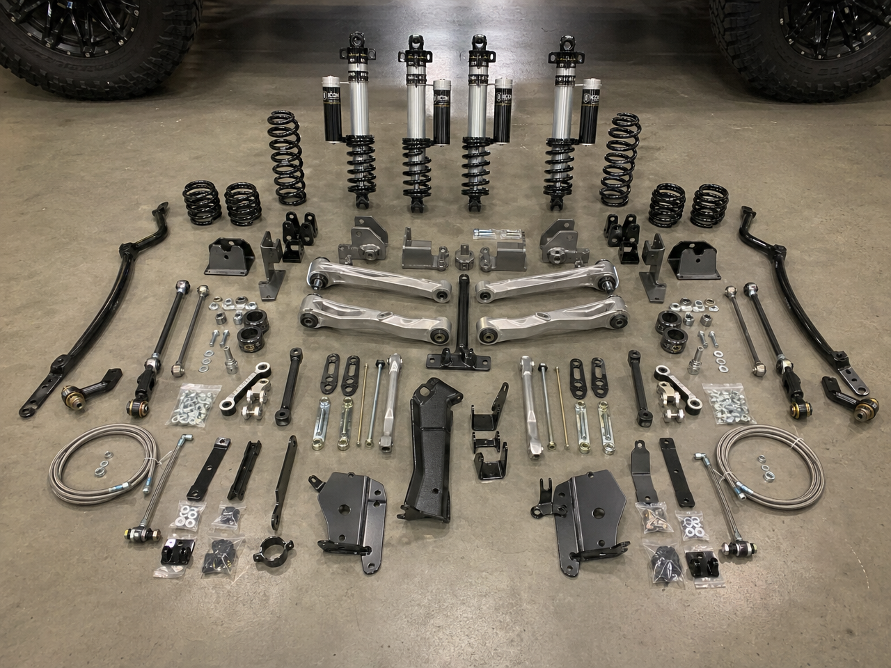 Complete Jeep JL lift kit components laid out on shop floor before installation