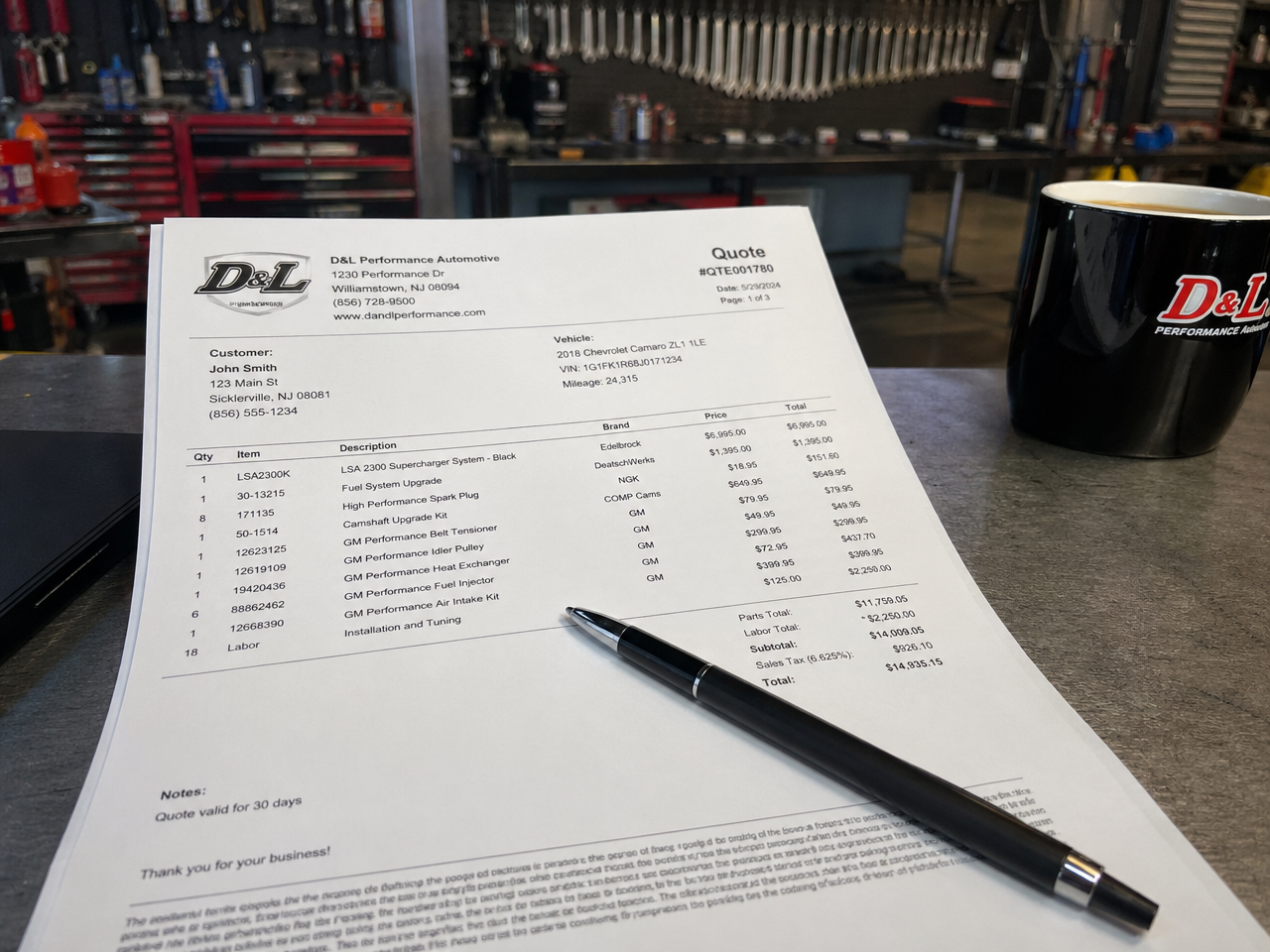Printed line-item build quote document on shop desk with pen and coffee cup