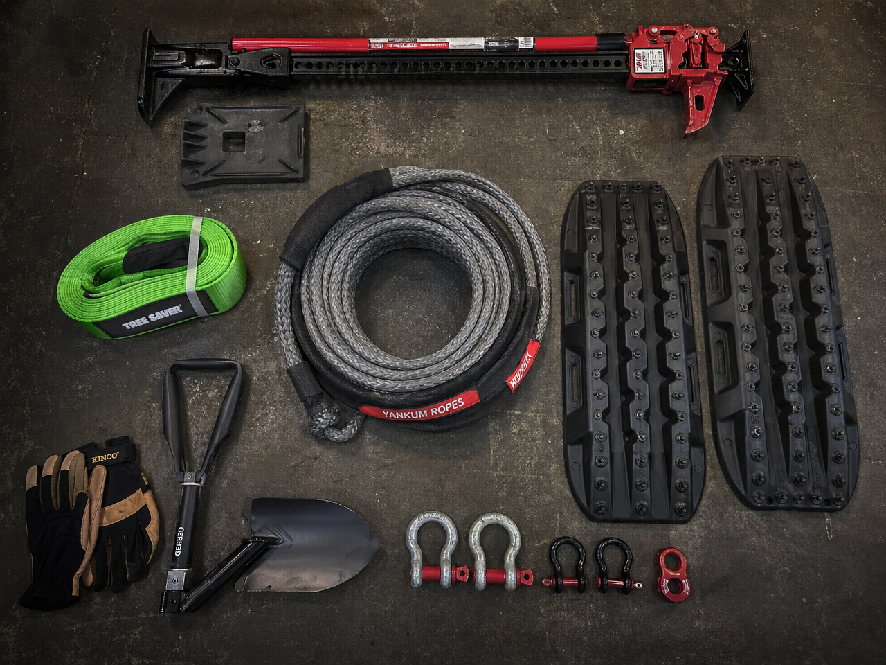 Complete off-road recovery kit flat lay including kinetic rope hi-lift jack recovery boards and shackles