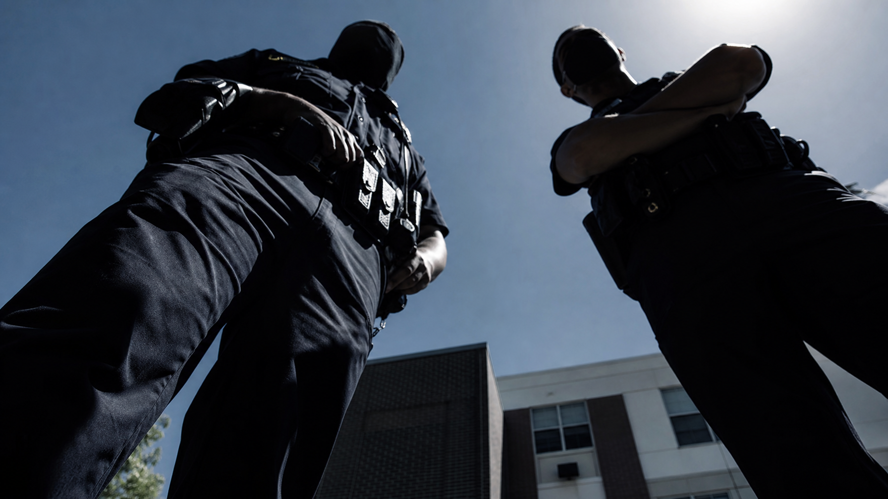 Camera POV looking up at officers
