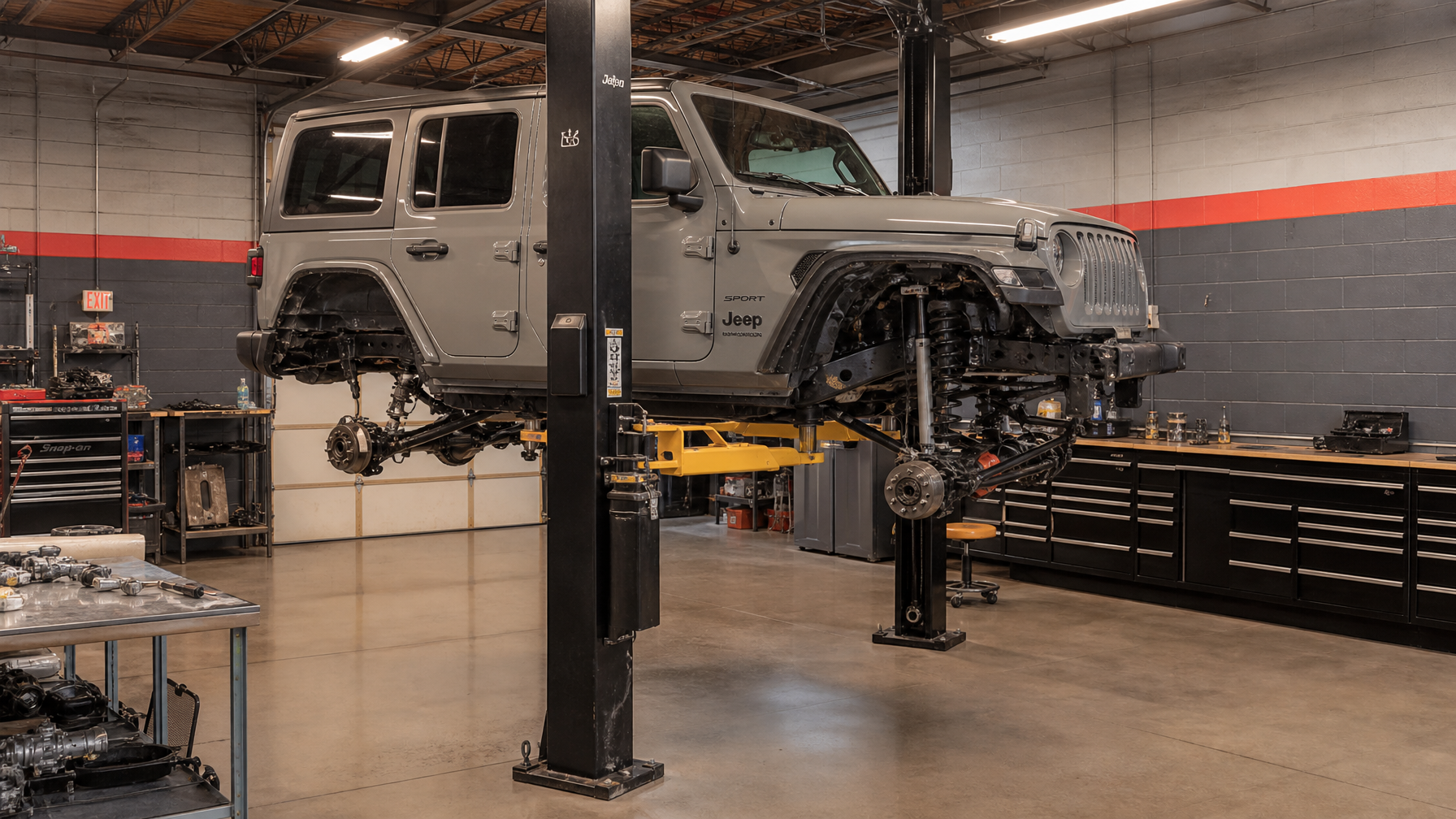 Jeep Wrangler mid-build in shop bay with suspension disassembled