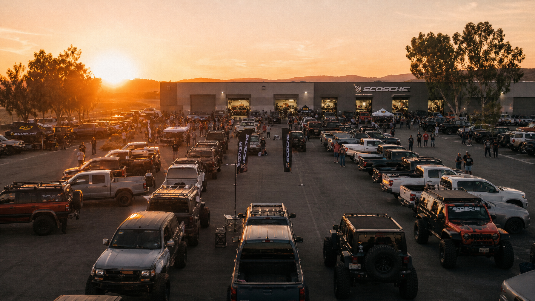 Off-road automotive community gathering in shop parking lot