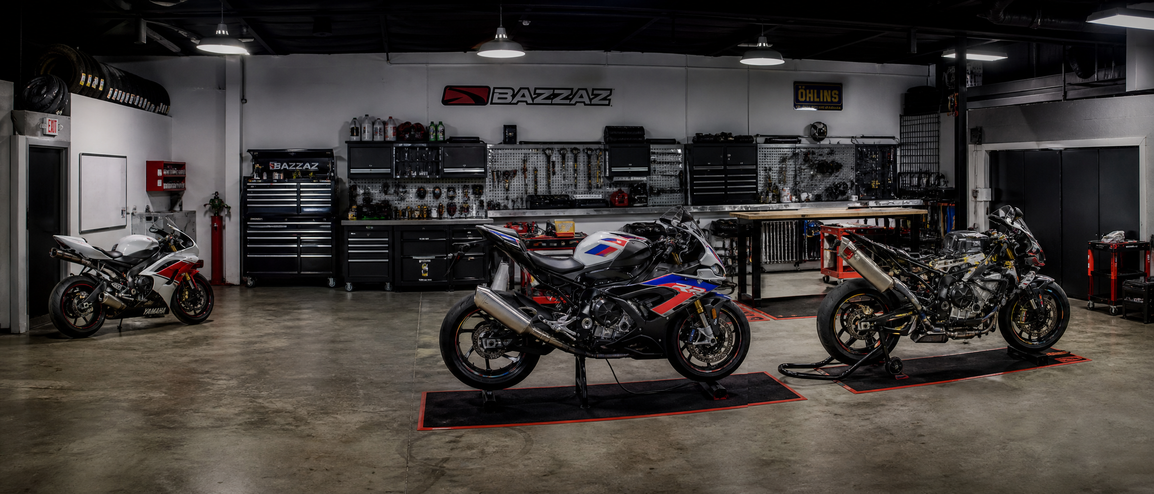 Professional sport bike performance shop floor — multiple bikes in service