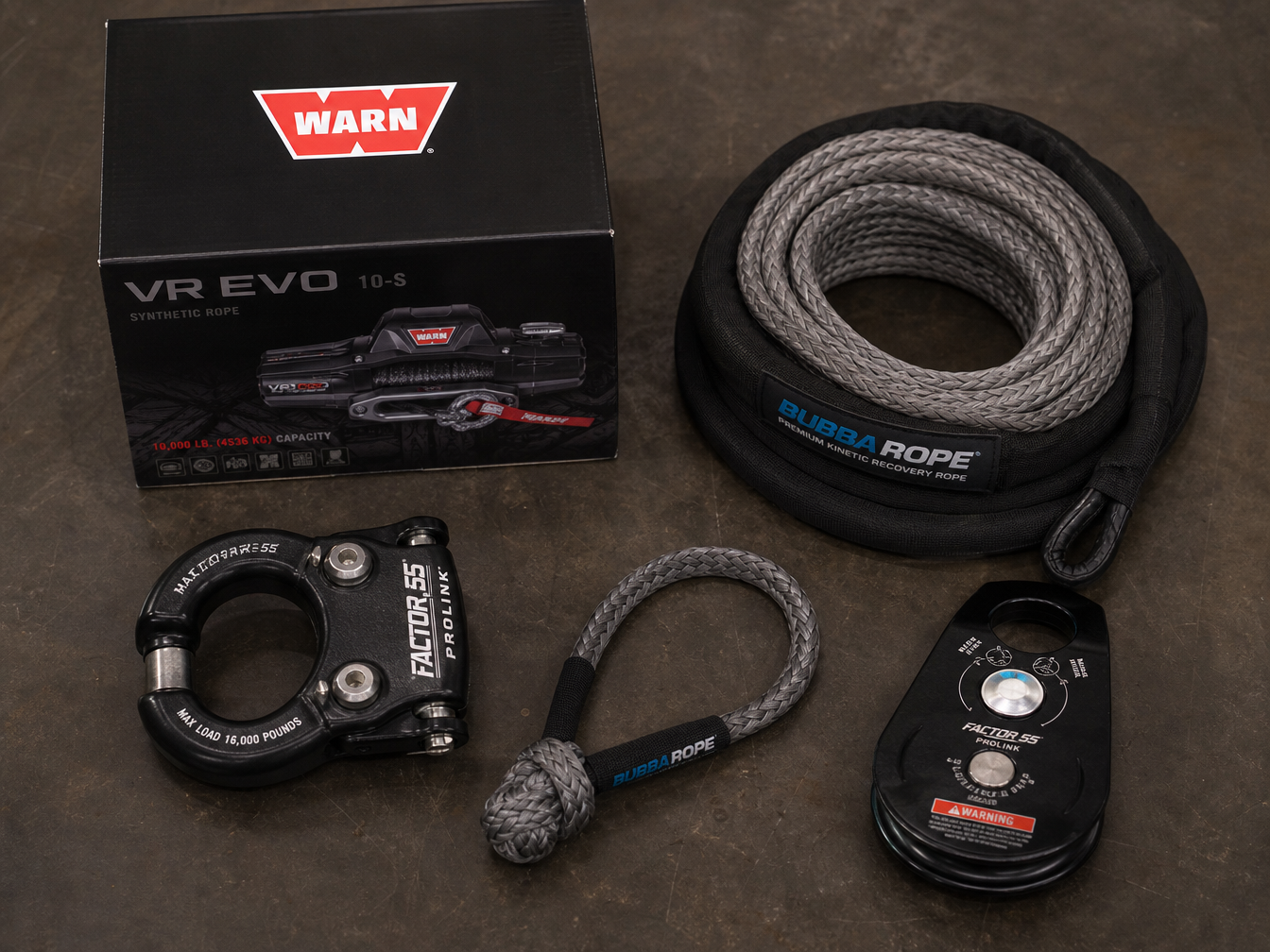 Jeep accessories flat lay including WARN winch, Factor 55 ProLink, soft shackles and kinetic rope