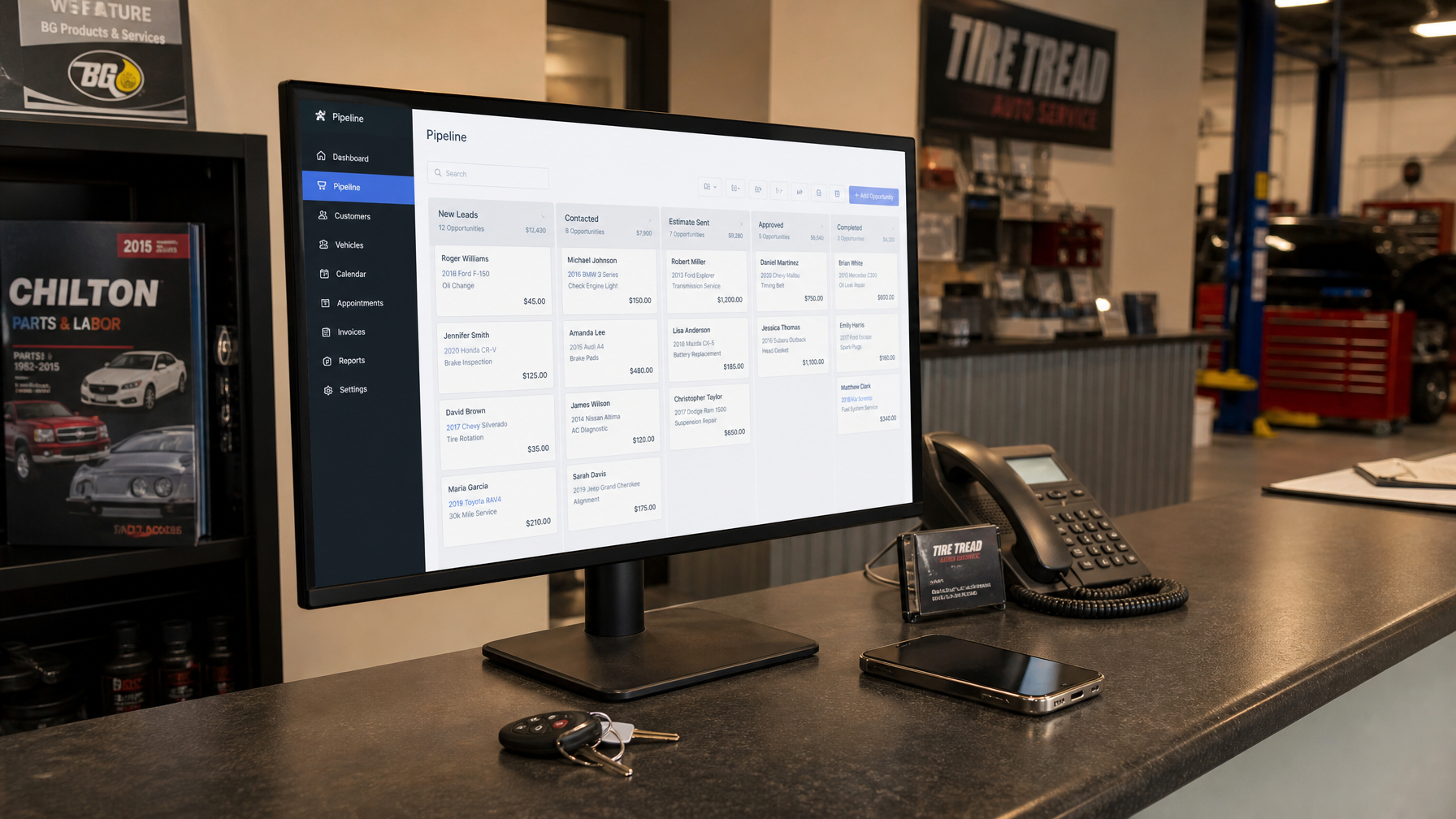 Auto shop reception desk with CRM dashboard on monitor
