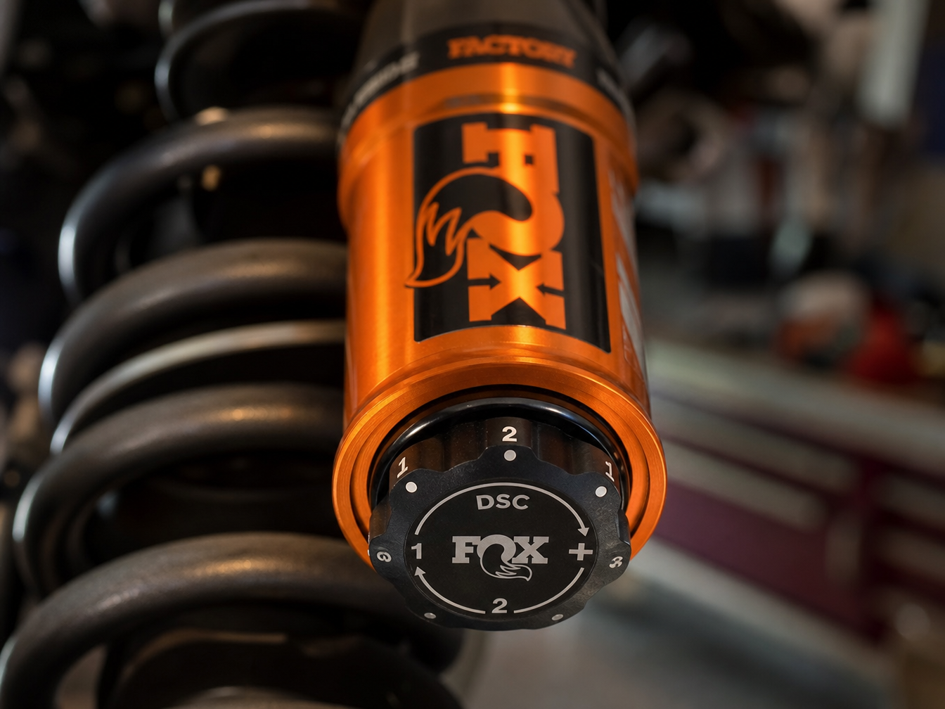 Fox DSC adjuster dial on an installed coilover body showing compression adjustment
