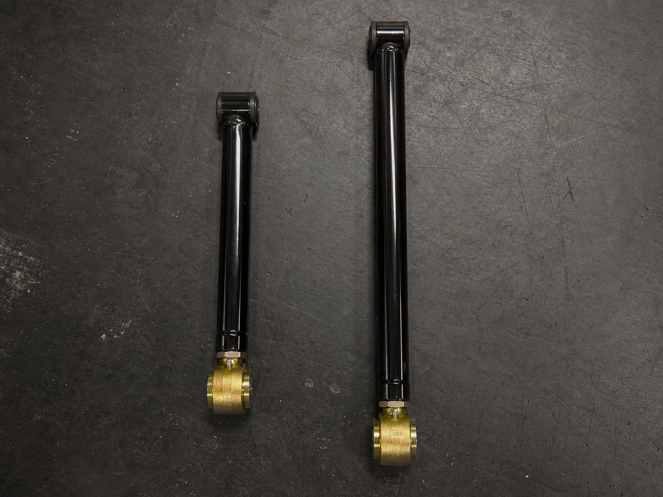 Short arm versus long arm control arm side by side showing dramatic length difference