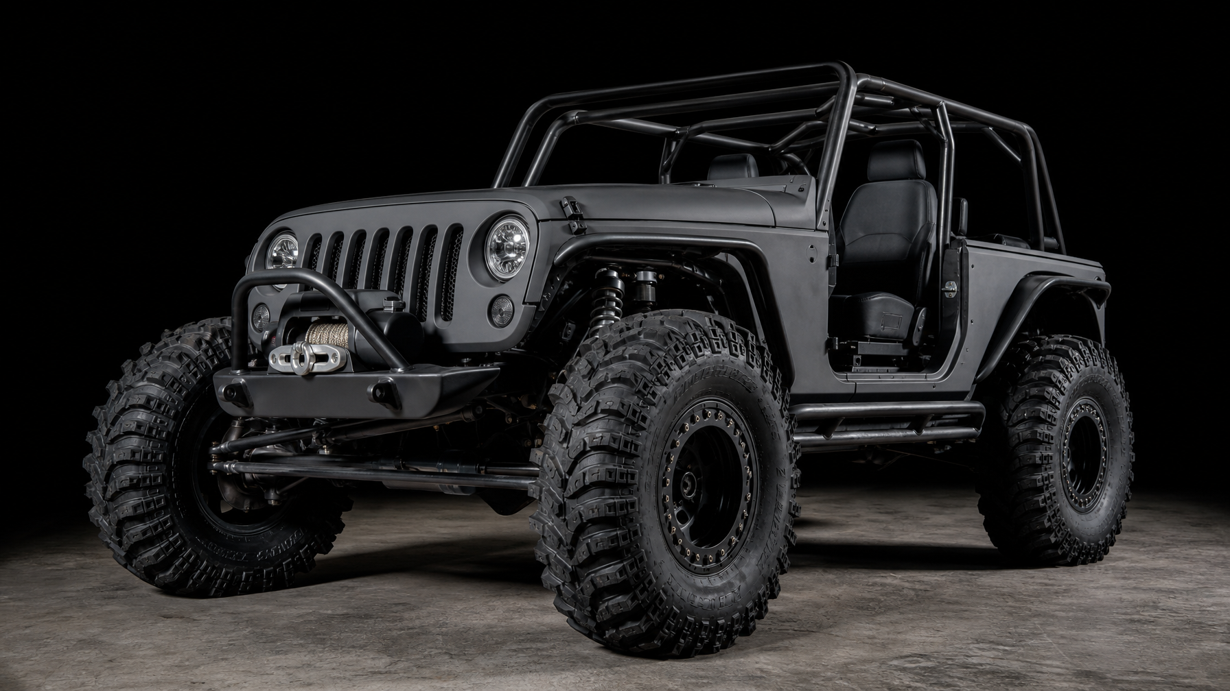 Stripped Jeep Wrangler JK rock crawler with DOM tube cage and 40 inch TREPADOR tires representing Level 3 Stage 3 build