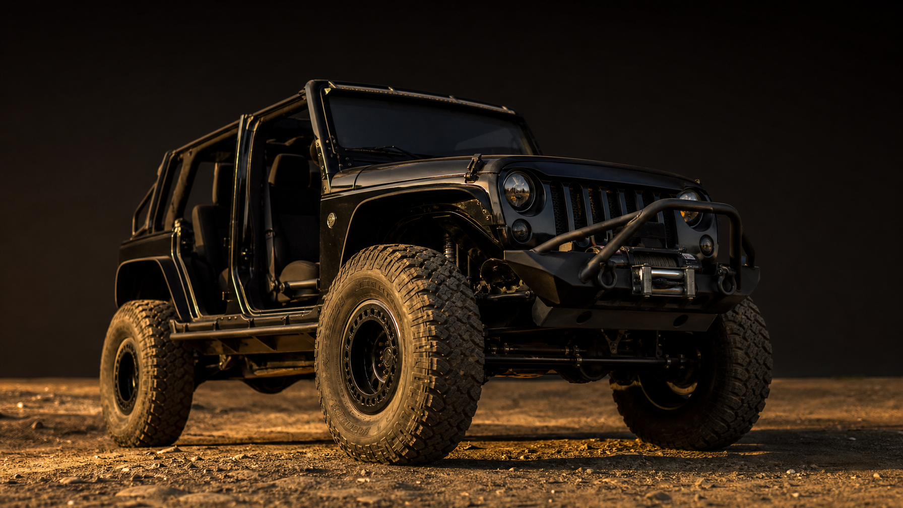 Black Jeep Wrangler JK trail rig with 37 inch TREPADOR tires and full armor representing Level 2 trail build