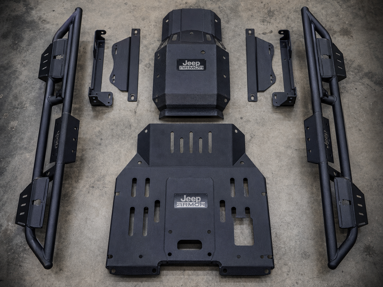 Completed custom fabricated Jeep armor package components with bed liner finish staged on shop floor ready for installation