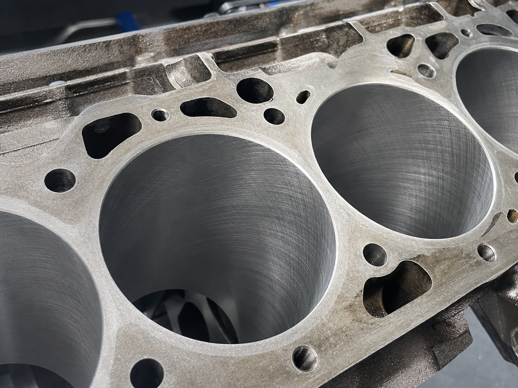 Freshly machined cylinder bores during a classic car engine rebuild