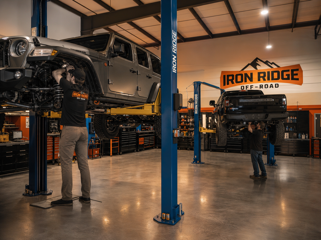 Iron Ridge Off-Road shop interior with lifted rig on hoist