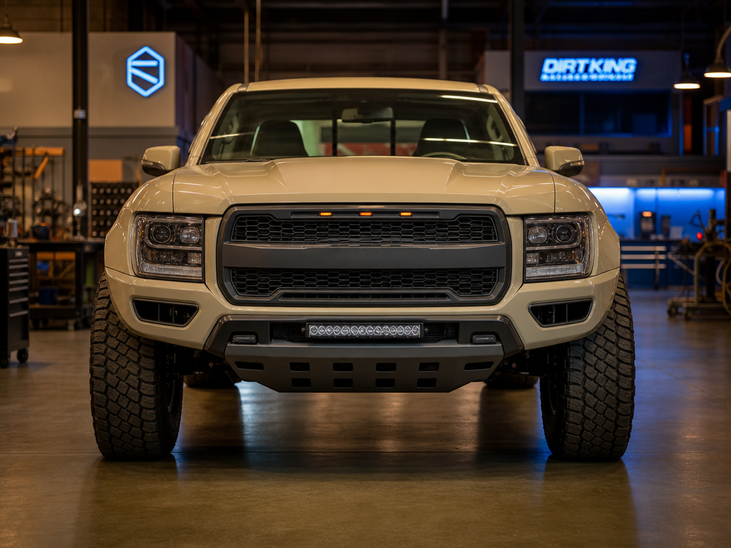 Long-travel front end mid-build on a truck on a shop hoist