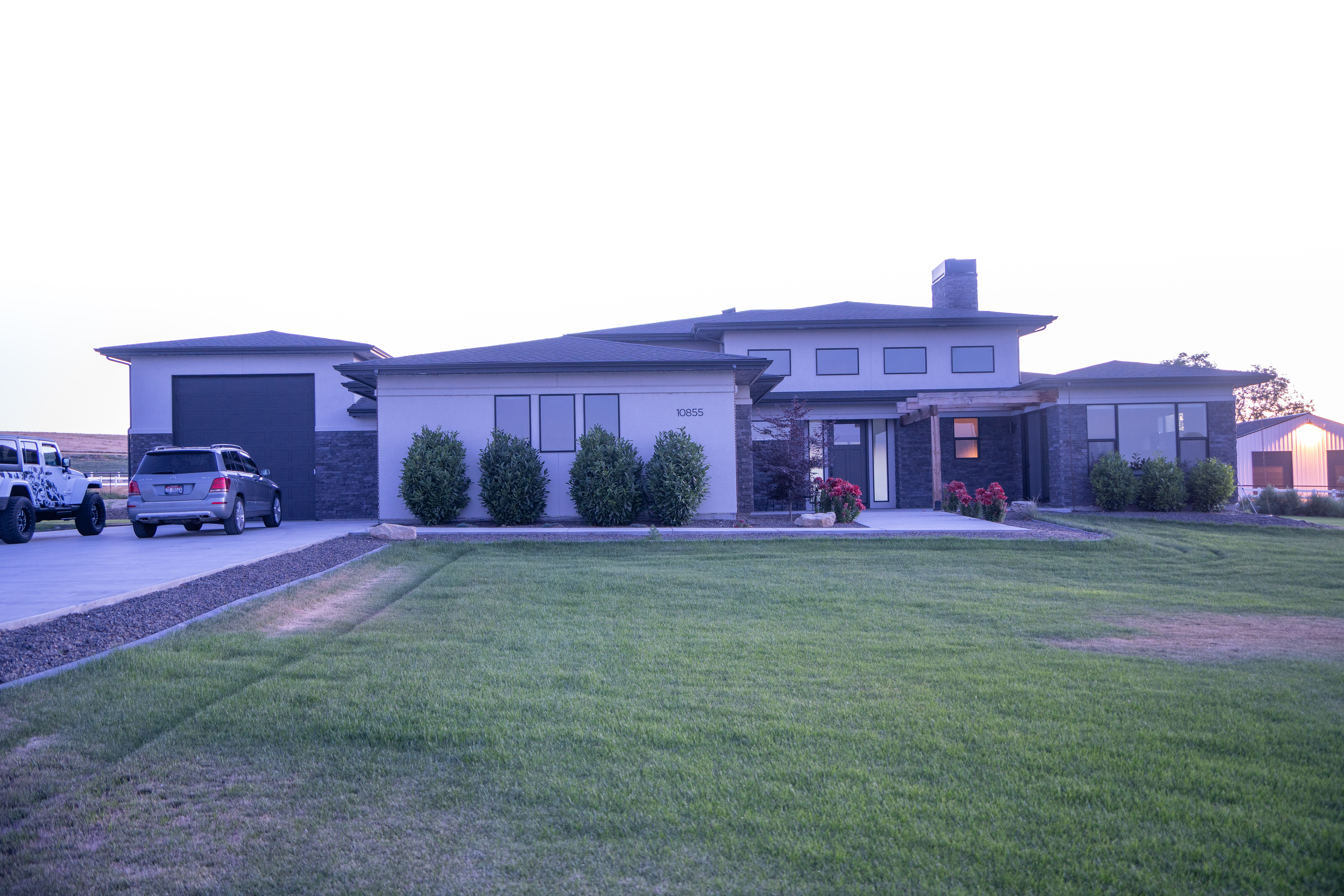 Modern home in daylight with permanent lighting track tucked discreetly under the roofline