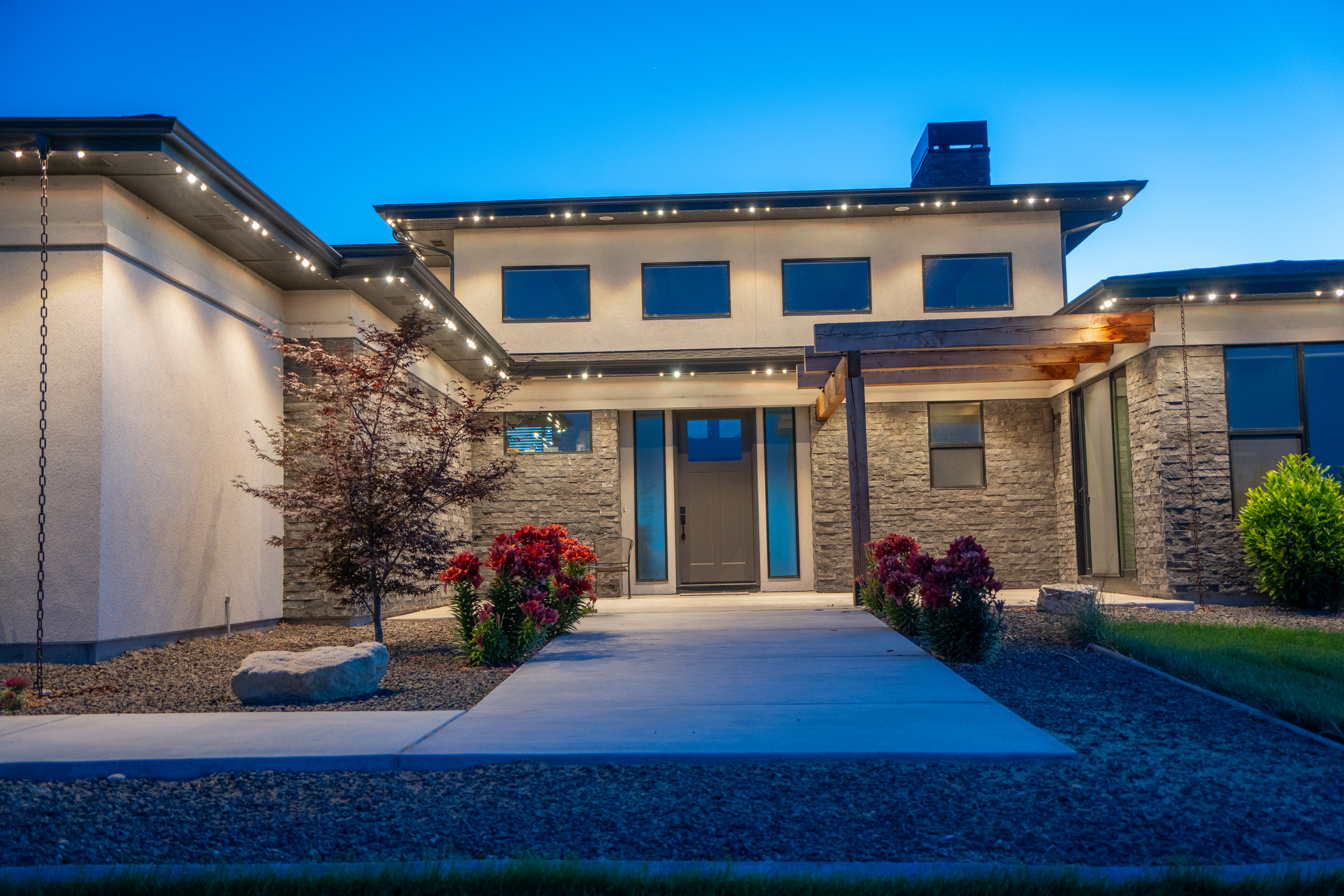 Front entry with permanent white lighting at twilight