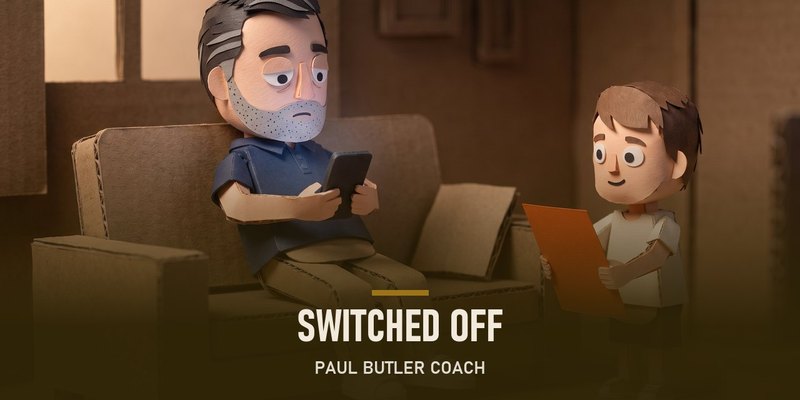 Dave on the sofa on his phone while his son waits with a drawing