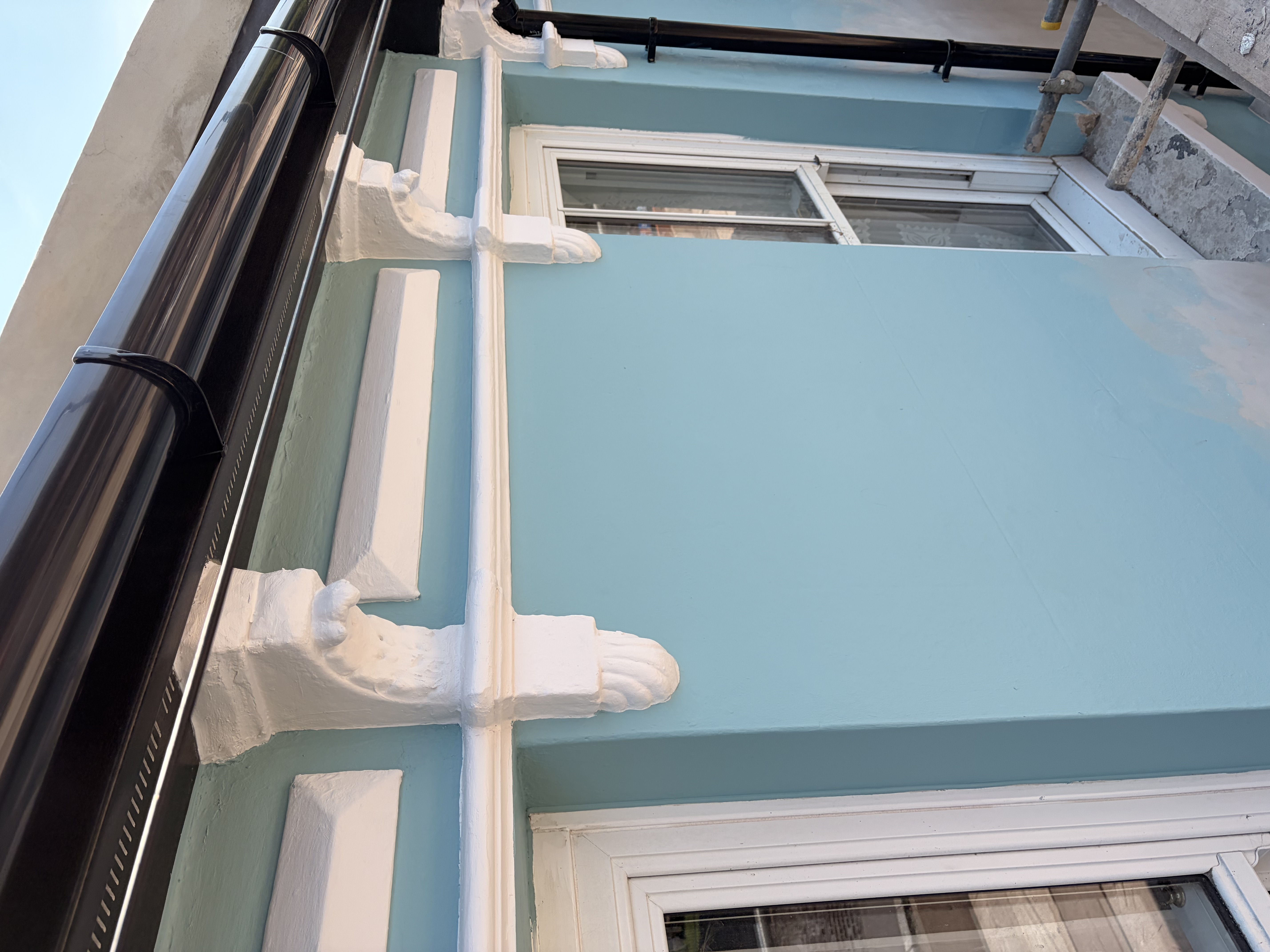 Repainted decorative corbels and window trim, East Sussex