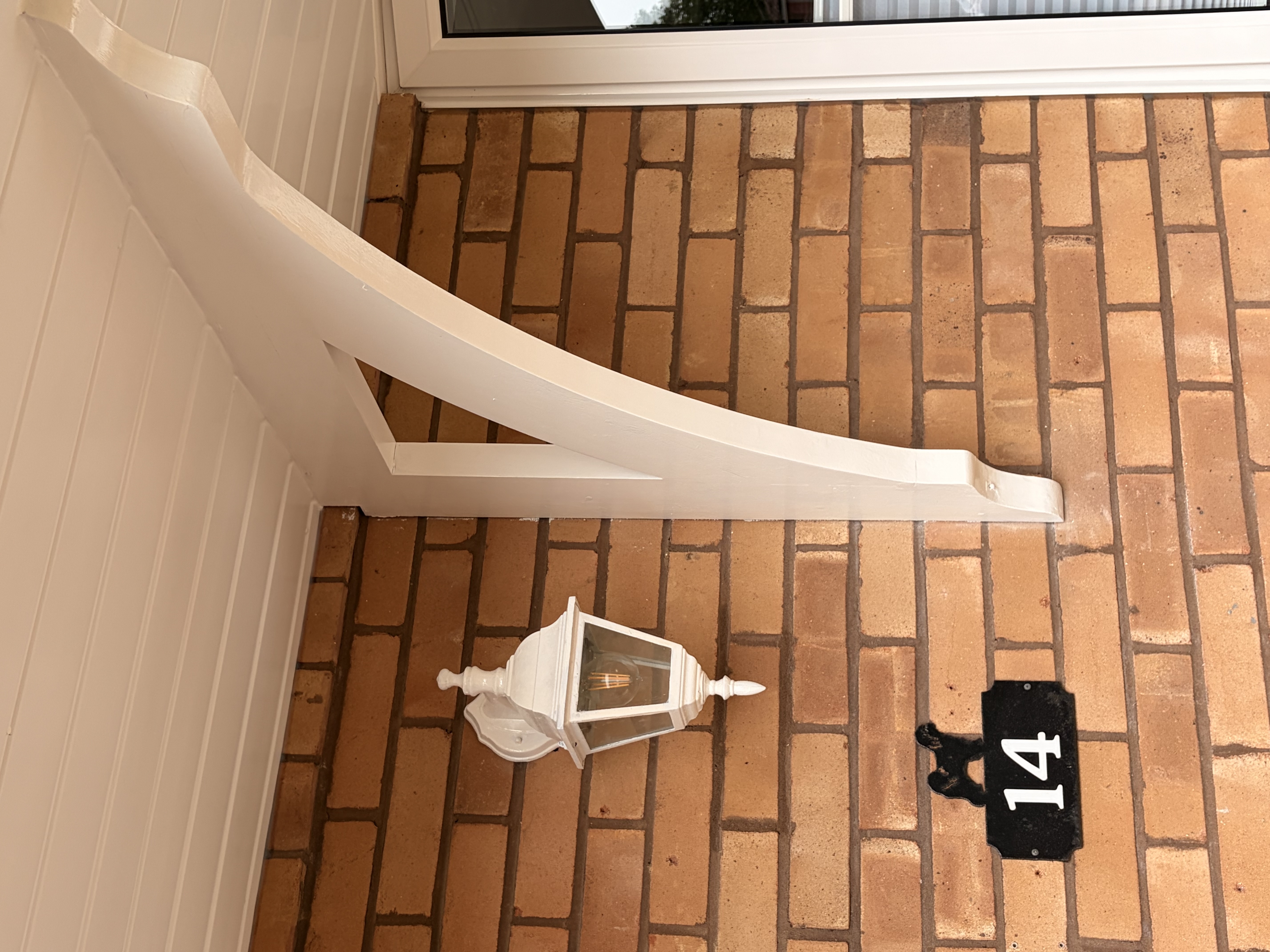 Repainted porch bracket and lantern, East Sussex