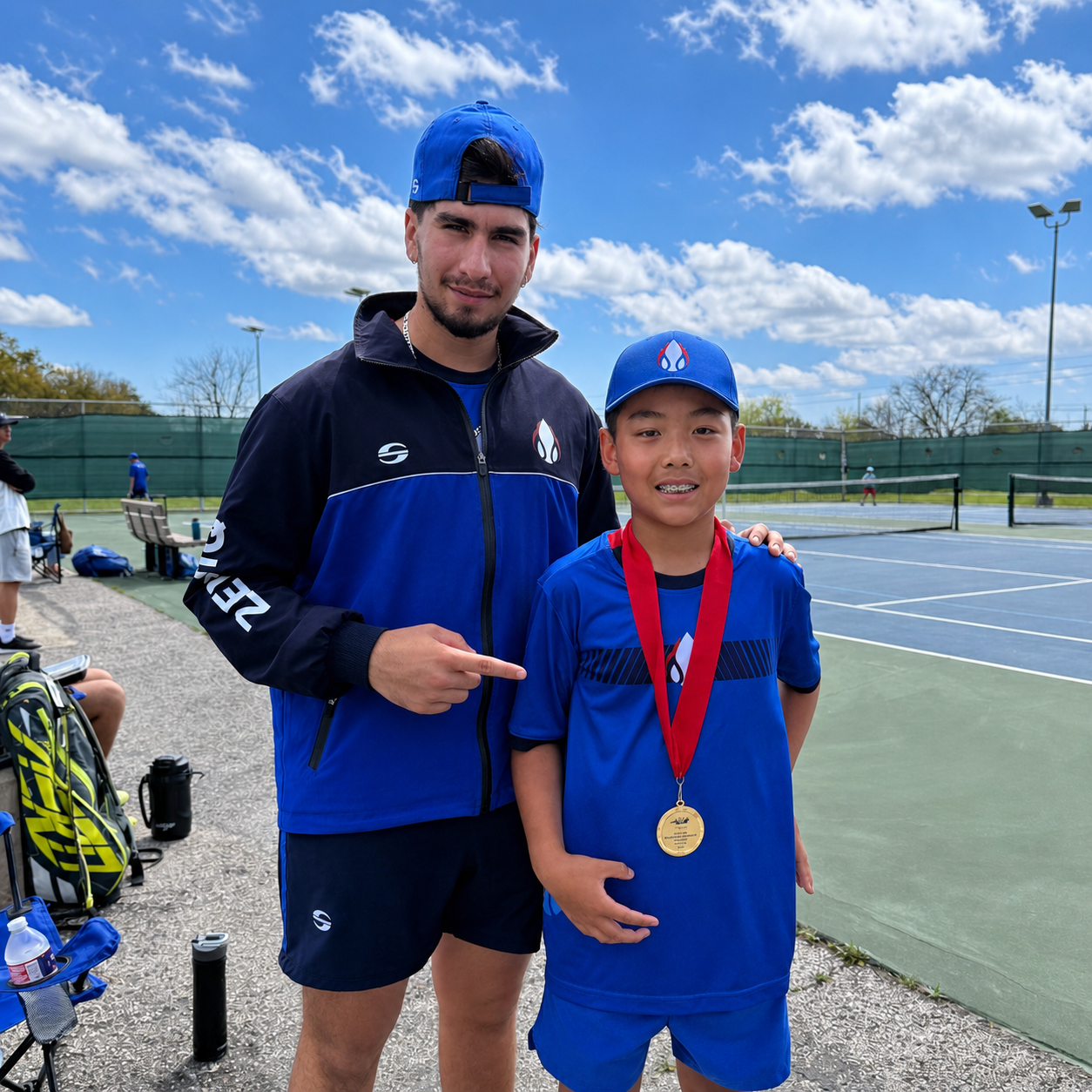 Coach Rafael Rovero with a junior tennis player holding a medal after serious tennis practice and tournament achievement