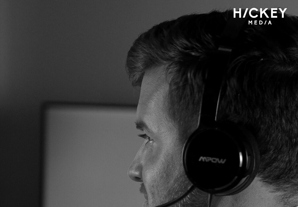 Blake Hickey on a call in his studio, wearing a headset