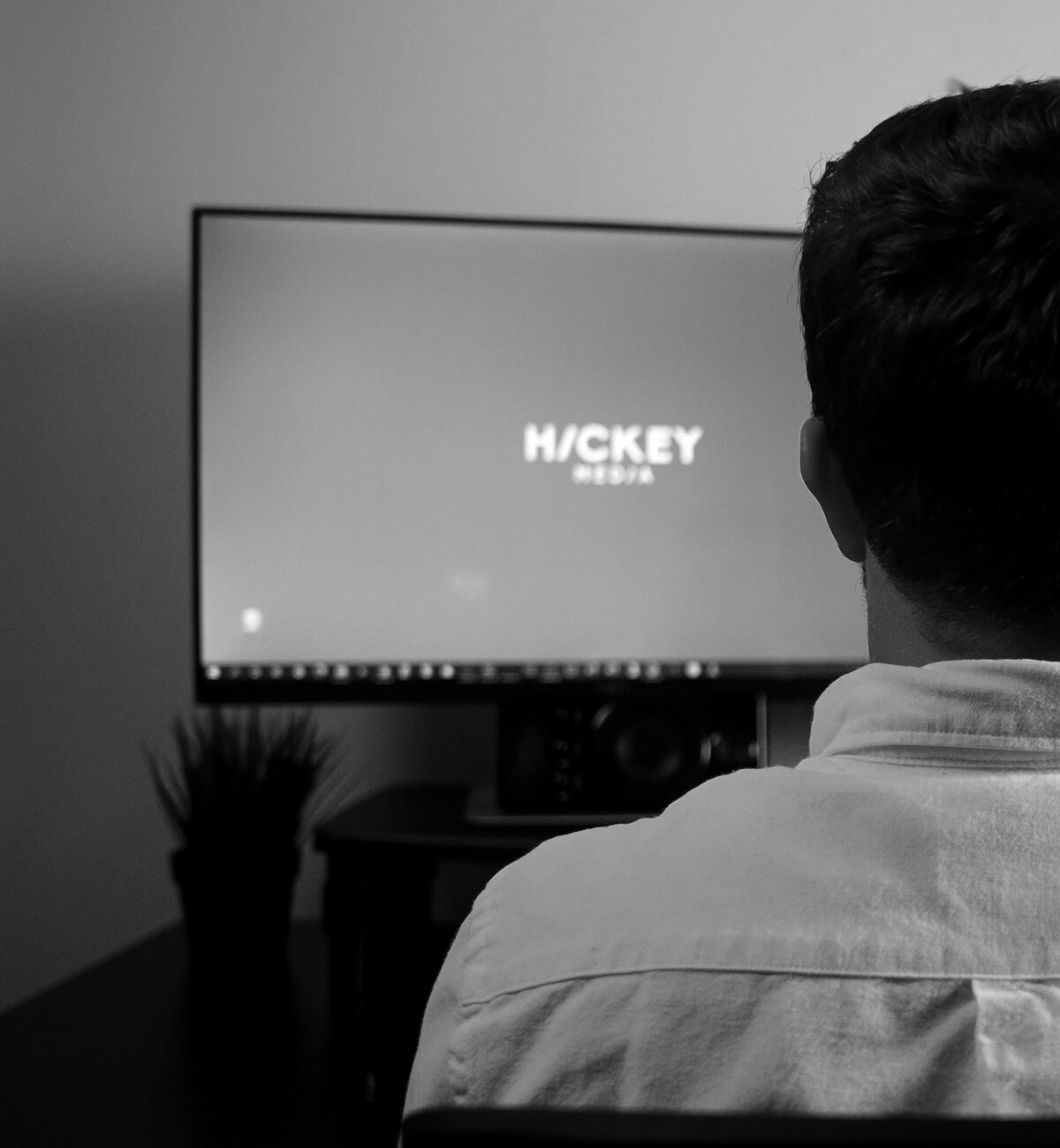 Blake Hickey at a monitor showing the Hickey Media logo