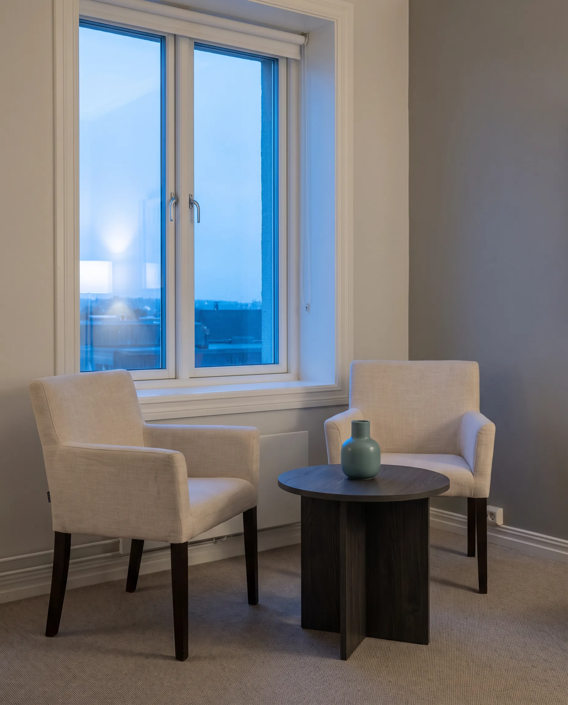 Illustrative image, not a real clinic: a quiet therapy room with two chairs at a small table