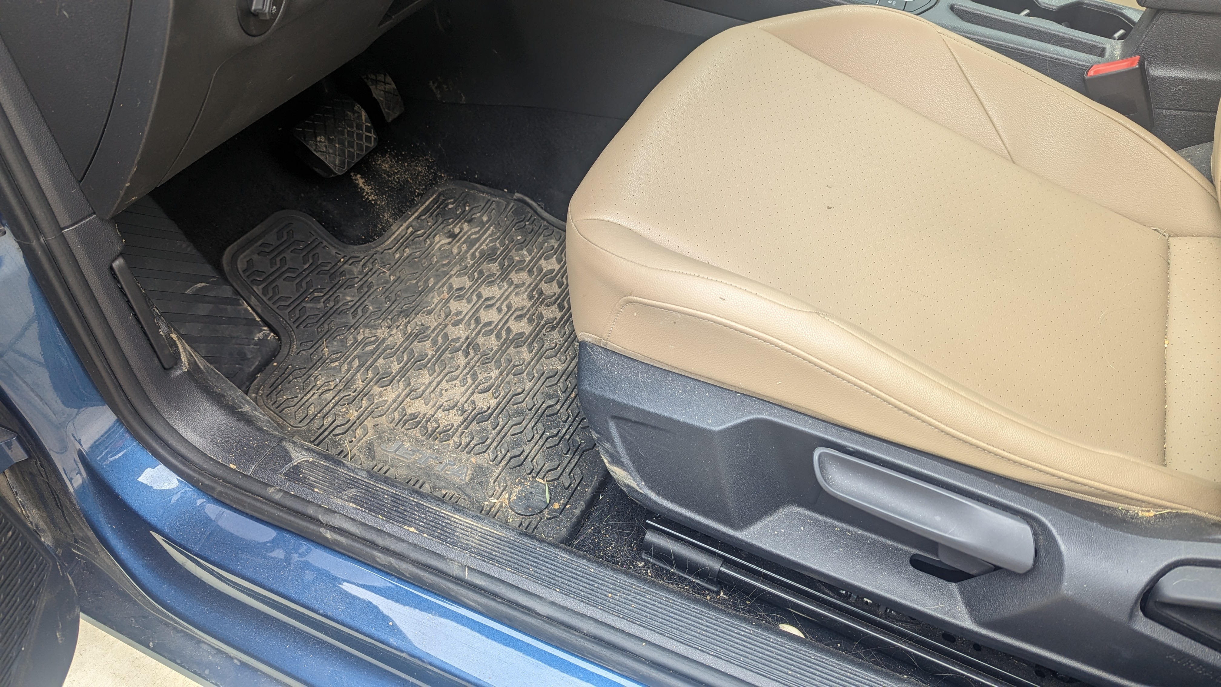 VW Jetta interior before deep detail — dirty floor mats and debris