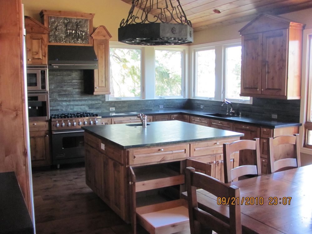 Kitchen renovation with custom cement countertops and modern cabinetry by Square Up Construction