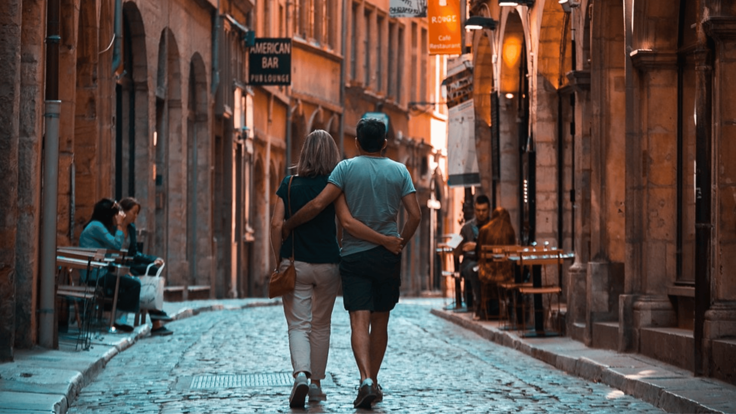 Couple walking cobblestone European street