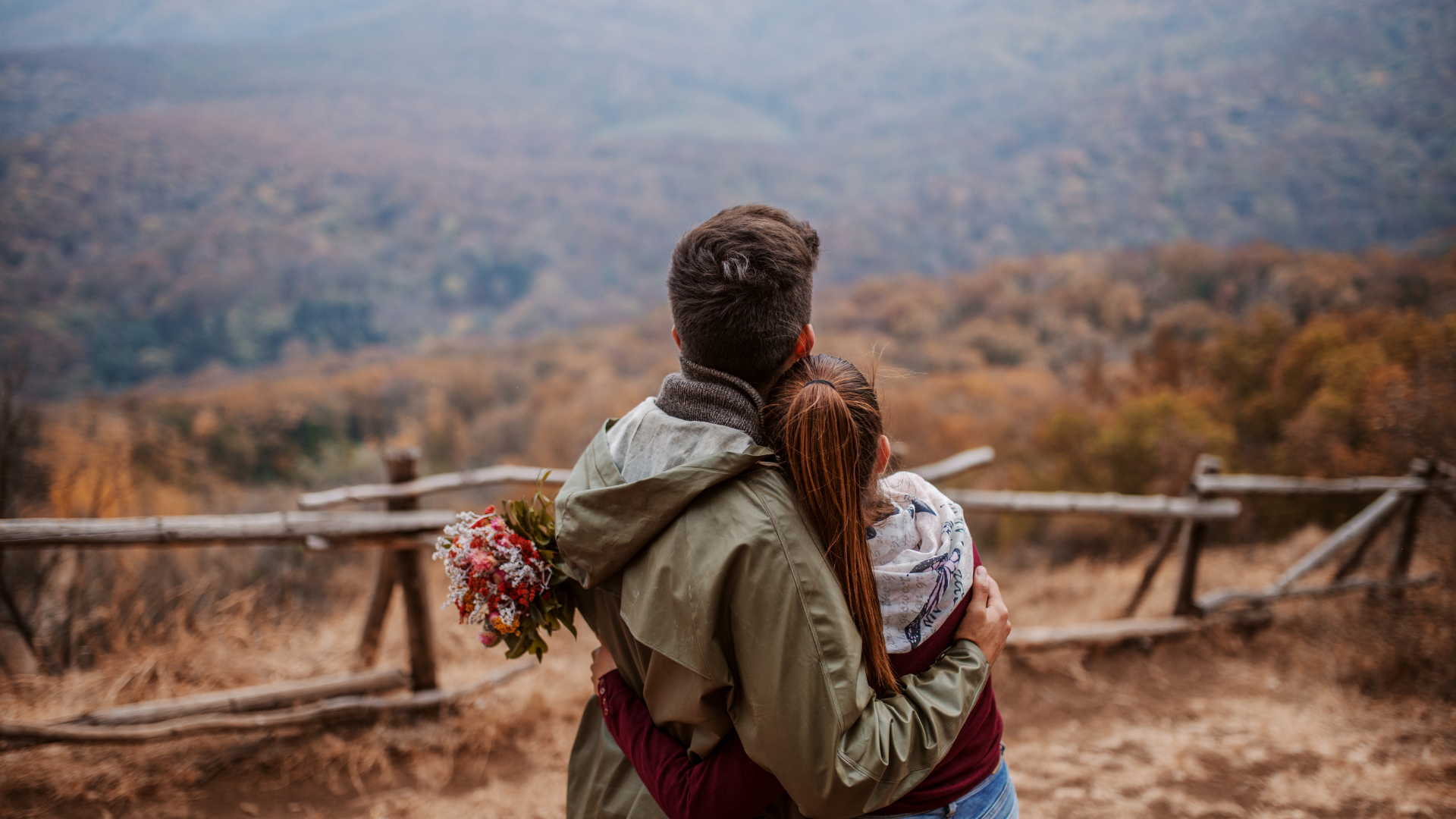 Couple watching from the mountaintop Couple watching from the mountaintop