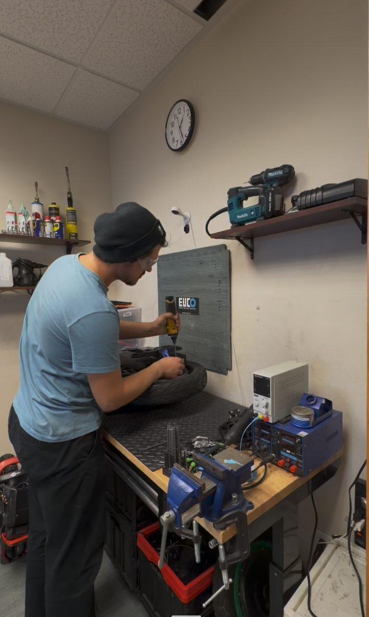 Technician servicing a product at the workbench