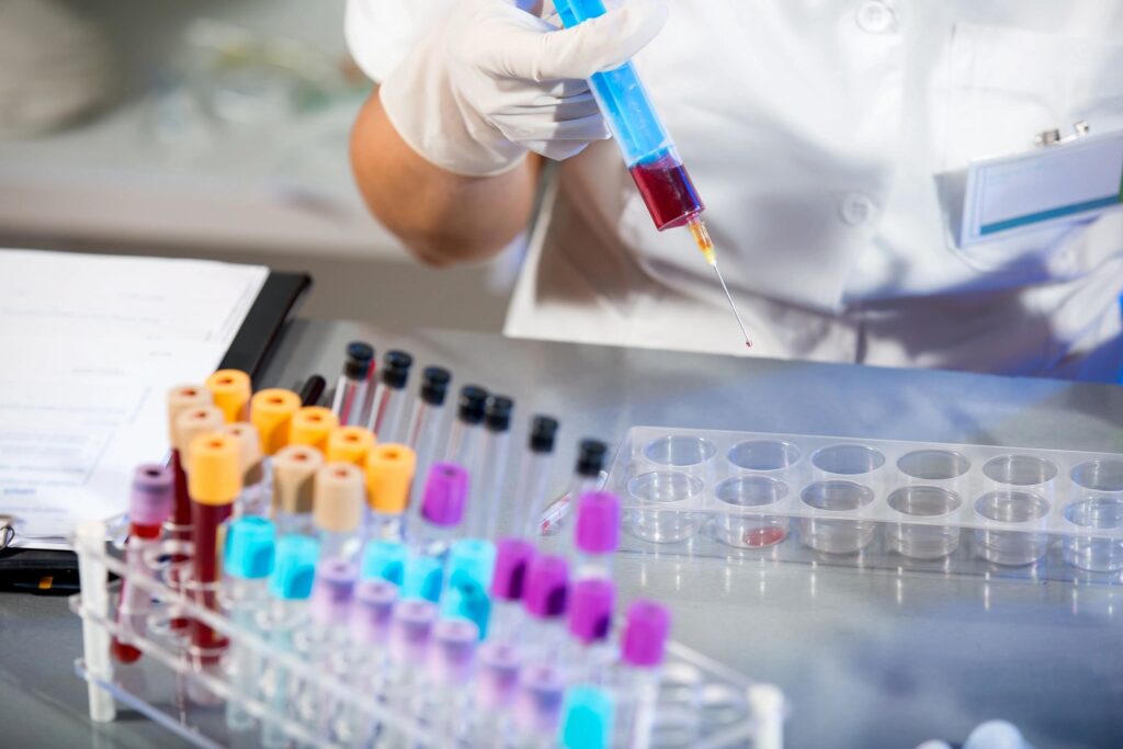 Close-up of a platelet rich plasma injection being delivered to a dog's arthritic joint using regenerative medicine at a veterinary clinic