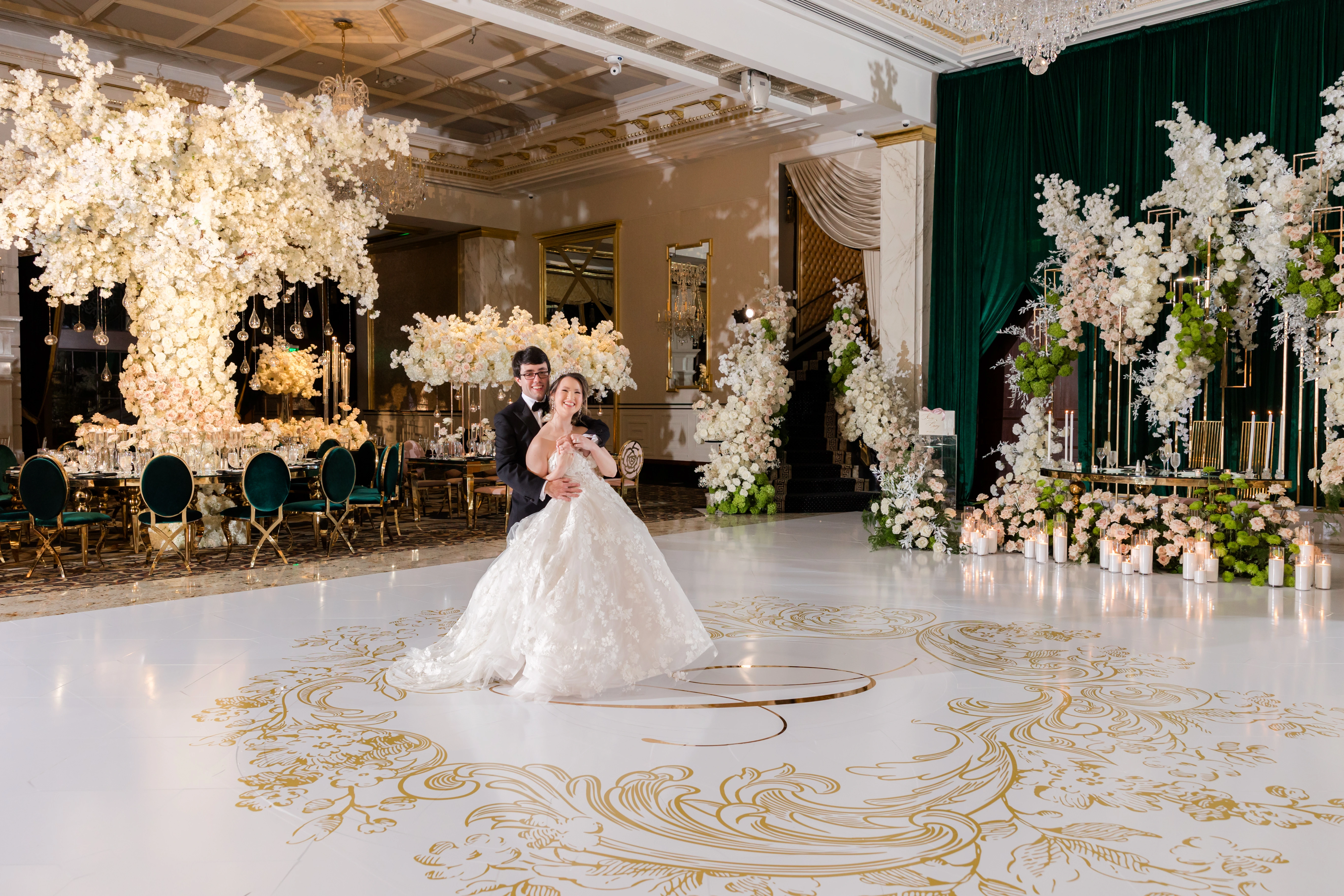 Reception hall with chandeliers and cascading florals