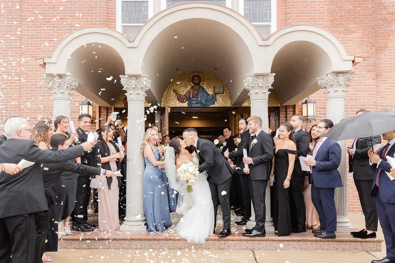 Eleni and Vasili — couple at the ceremony with the priest
