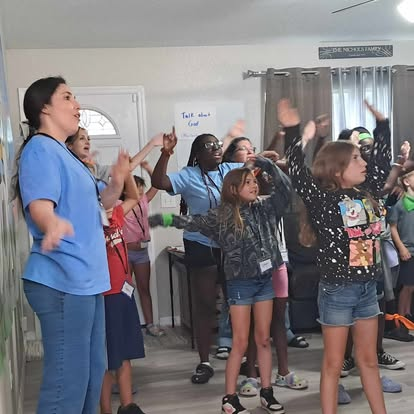 Children and volunteers worshiping together