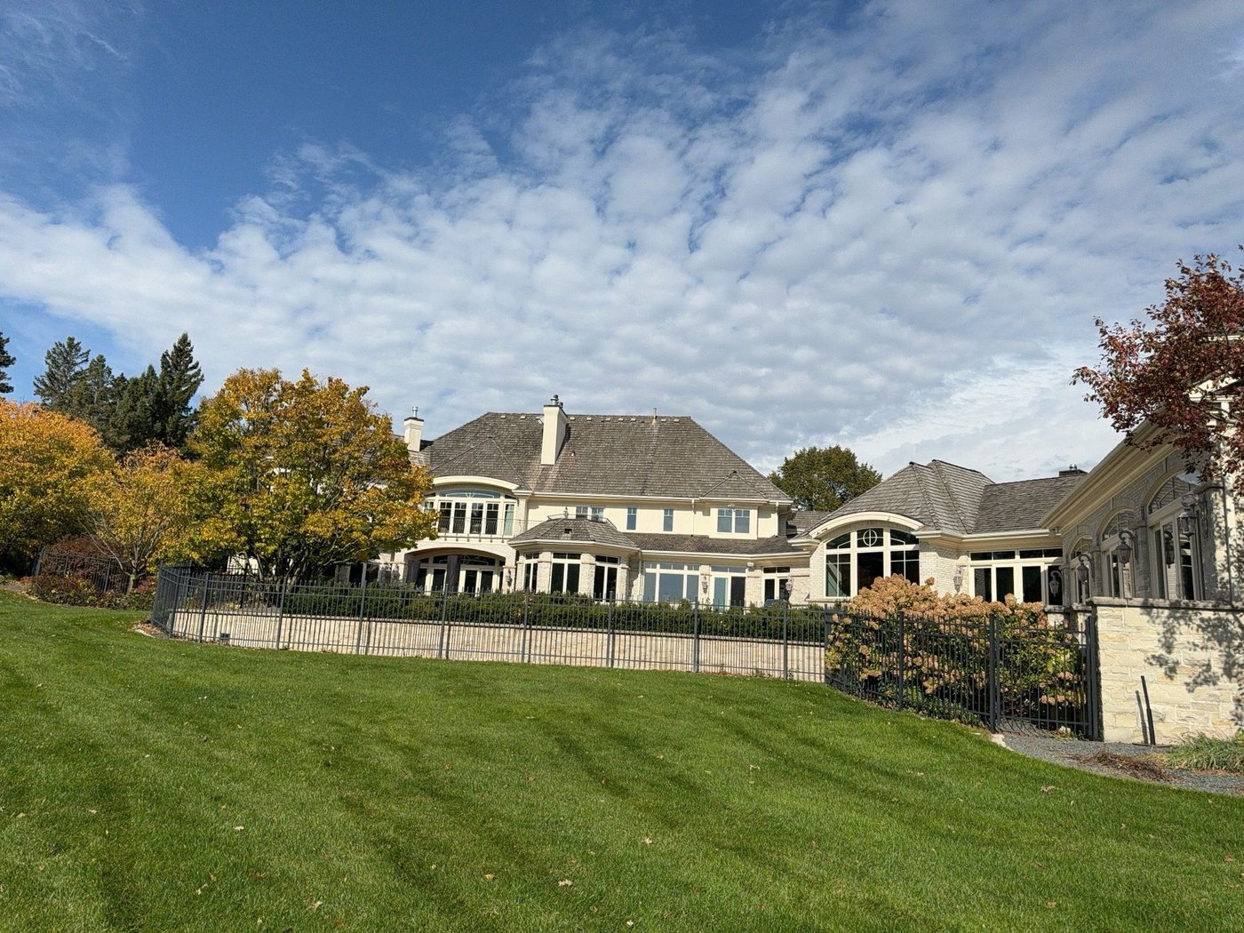 Lakeside estate seen across the lawn, with its full cedar shake roofline, October 2023