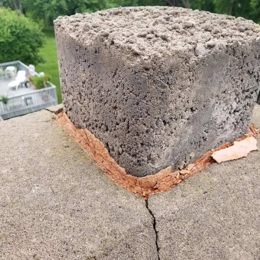 Crumbling mortar crown around a clay flue tile on a Coon Rapids, MN chimney, June 2017