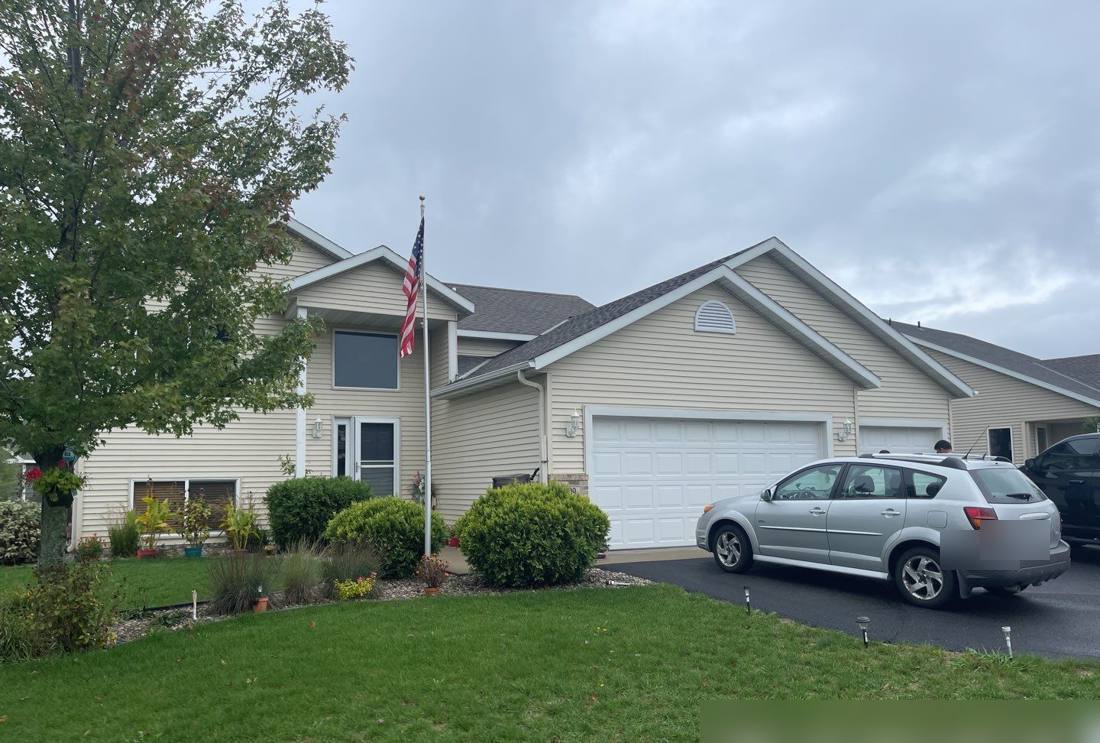 Two-story Sartell home with an American flag, photographed during a roof inspection, October 2021