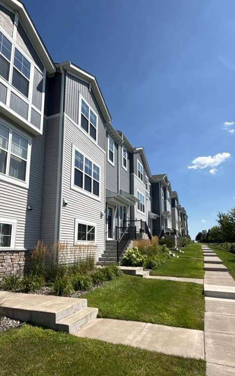 Row of three-story Lexington Woods townhomes in Roseville, MN during a Repair King inspection, August 2026