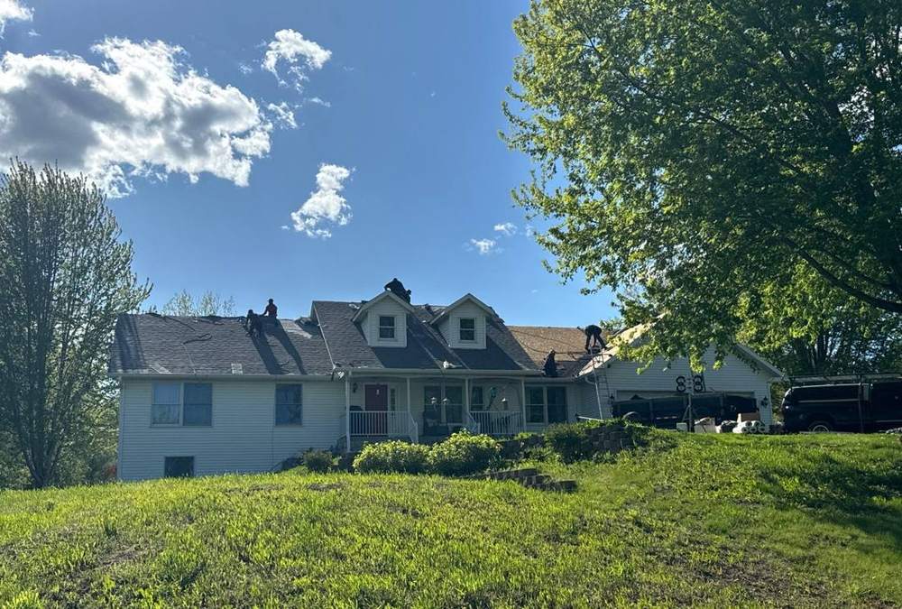 Repair King crew re-roofing a two-story home on 727th Ave near Dassel, May 2024