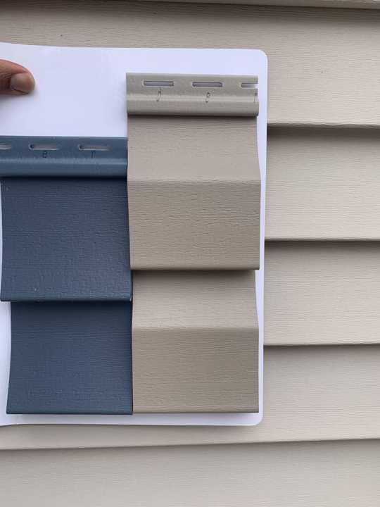 Manufacturer siding samples held against the old siding to match colors on the Plymouth home, March 2020