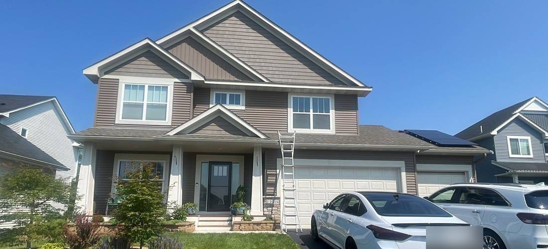 Two-story Rosemount home photographed during a roof inspection, July 2023