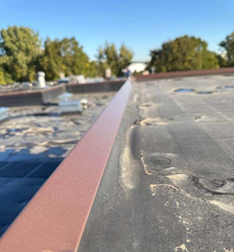 Metal coping cap at the roof edge of Wolfe Lake Condos, October 2024