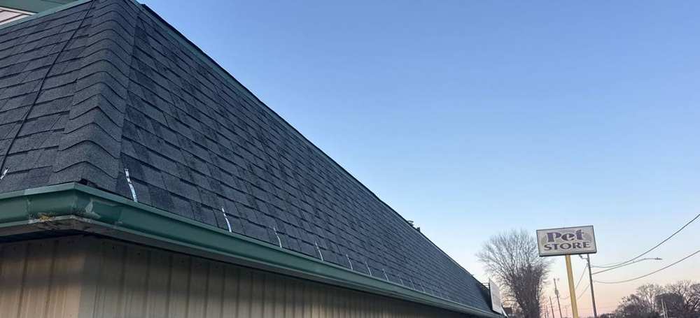 Shingle roof and rooftop sign at the Faribault Animal Center pet store on Grant Street in Faribault, MN