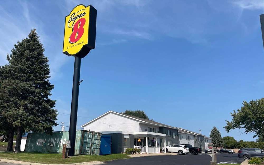 Super 8 sign and the motel's two-story buildings on Frontage Road West in Owatonna, MN, September 2022