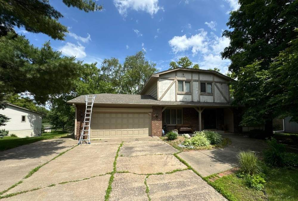 Two-story Maple Grove home with a distinctive octagon roofline, photographed during a 2024 roof inspection