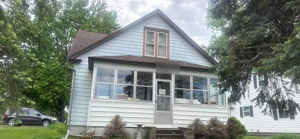 Older two-story home near South German Street in New Ulm during a roof inspection, May 2026