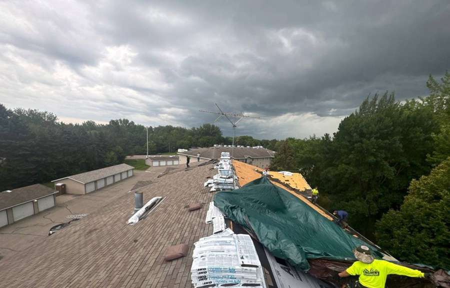 Shingle bundles staged on an apartment roof in Hutchinson, August 2024