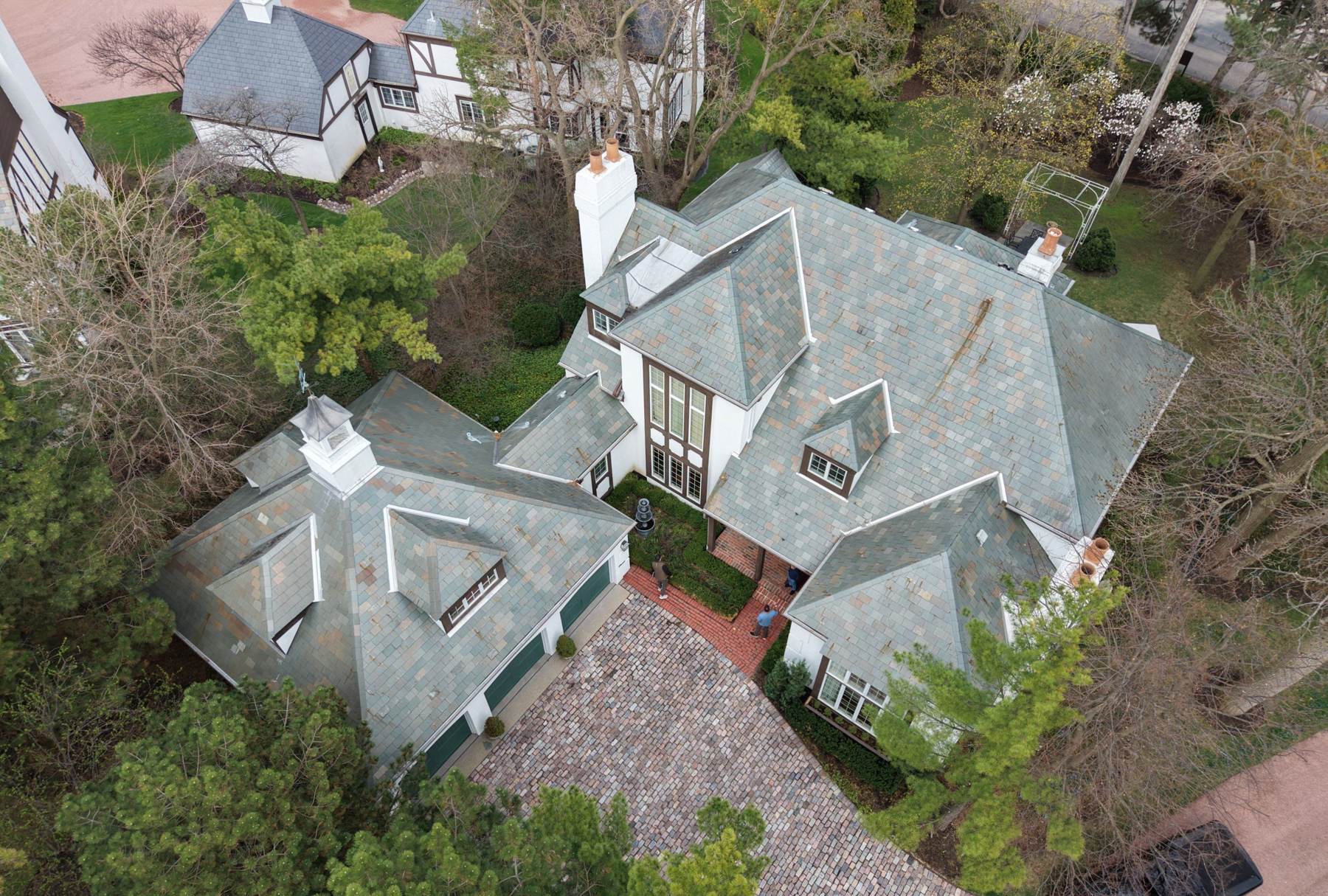 Aerial view of a large slate-roofed Tudor-style home in Burr Ridge, IL during a Repair King roof inspection, April 2026