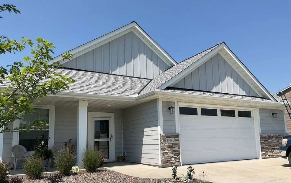 Single-story home with board-and-batten gables in Blaine, MN, photographed during a Repair King roof inspection in July 2023
